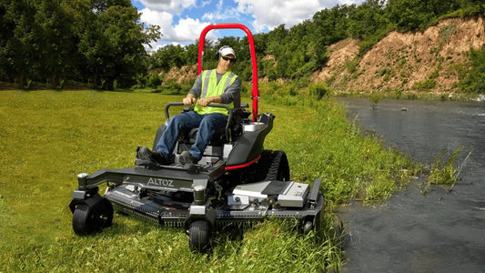 Operator test driving an Altoz TRX-766i all-terrain mower along uneven terrain near Somerset, KY.