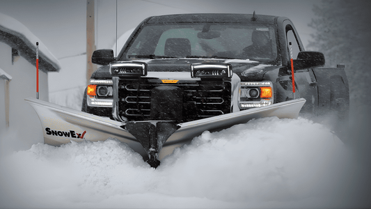 SnowEx snow plow mounted on a pickup truck clearing deep snow, highlighting the benefits of buying SnowEx equipment from a local Somerset, KY dealer.